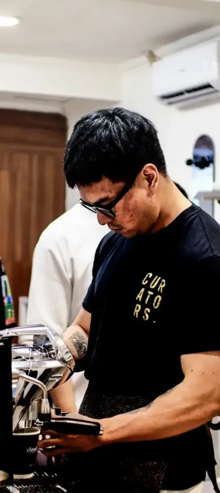Barista pulling an espresso shot behind the bar