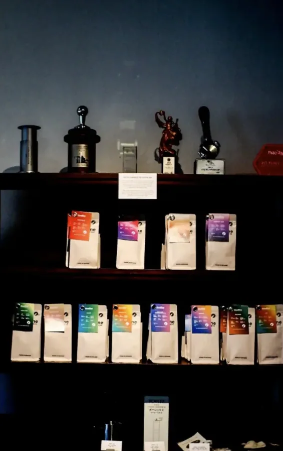 Shelf with Cloudline bags in coloured labels under a row of trophies